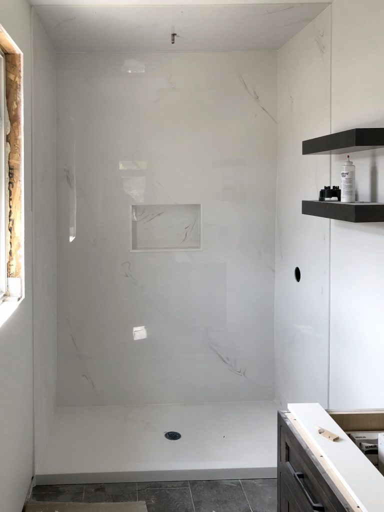 Complete with shower base, walls, ceiling panel & niche.
